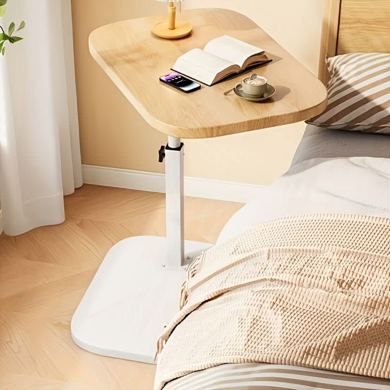 Height-adjustable side table with wooden top and metal C-shaped frame for sliding under sofas and beds for the living room